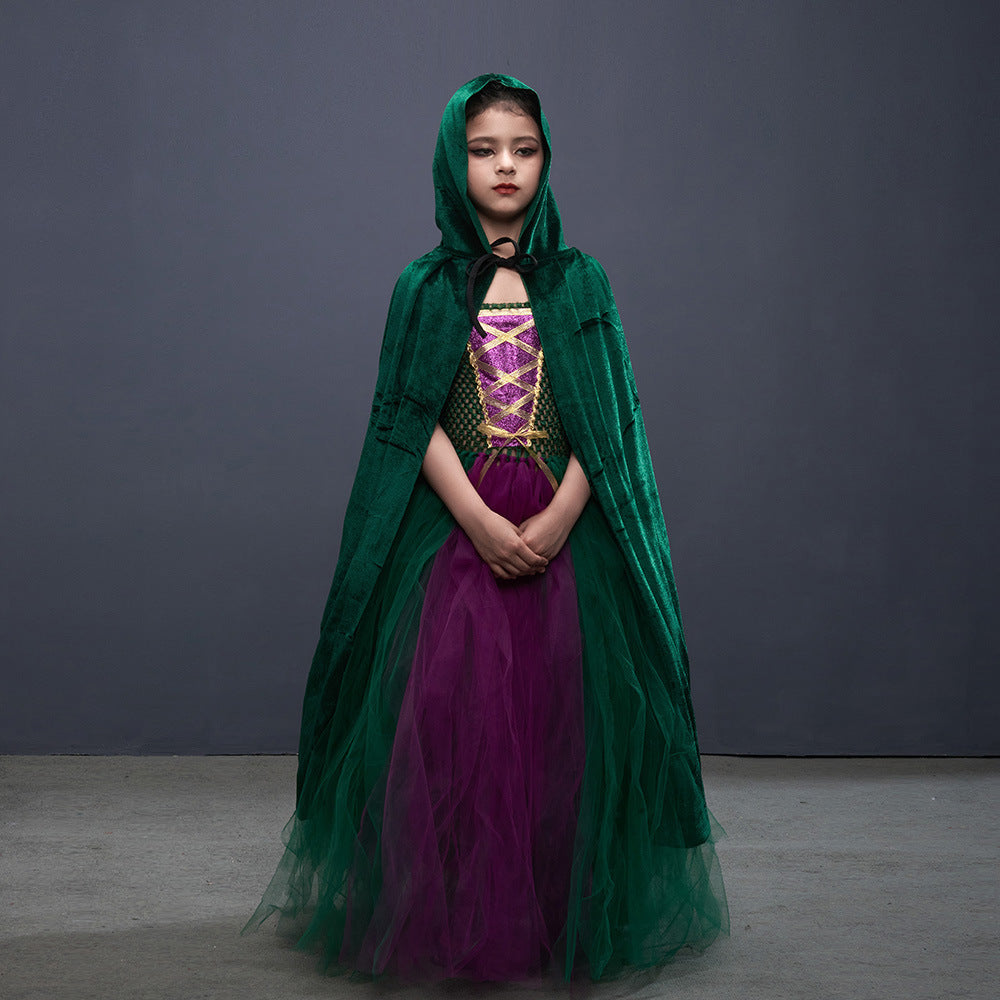 Person wearing a green hooded cloak over a purple dress against a gray background