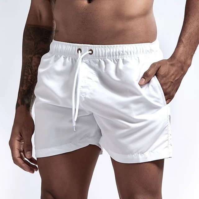 White shorts worn by a person on a plain background