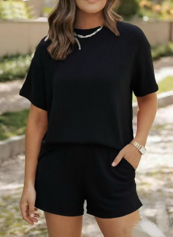 Woman wearing a black outfit with shorts outdoors