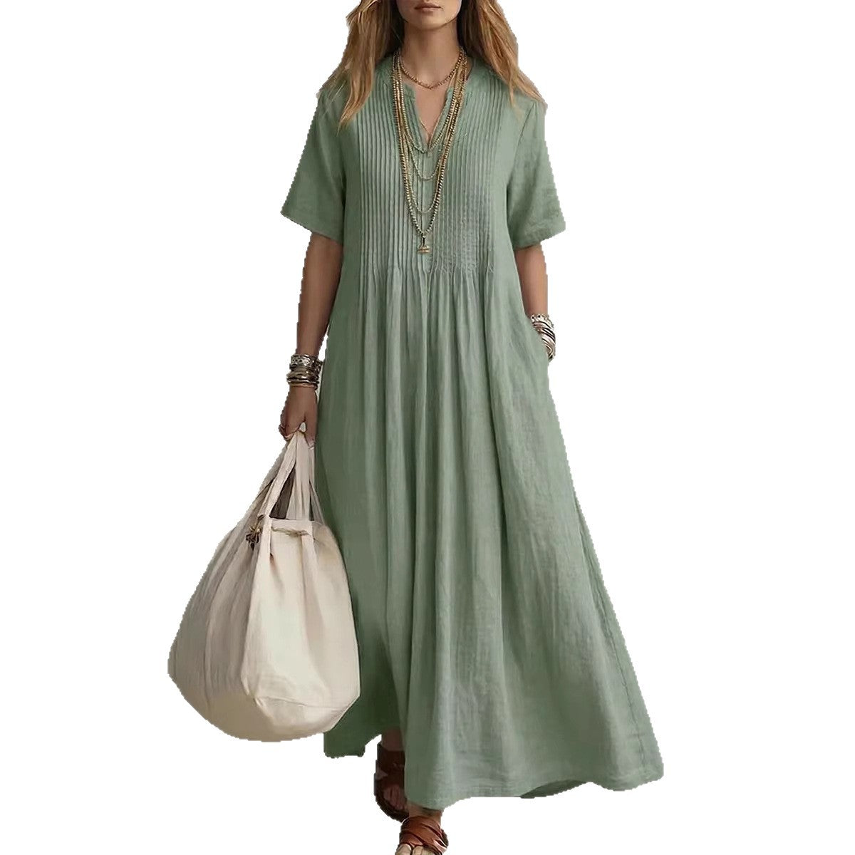 Woman wearing a green dress holding a beige tote bag on a white background