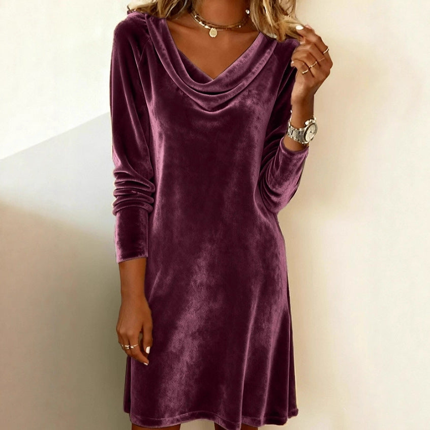 Purple velvet dress worn by a person on a plain background