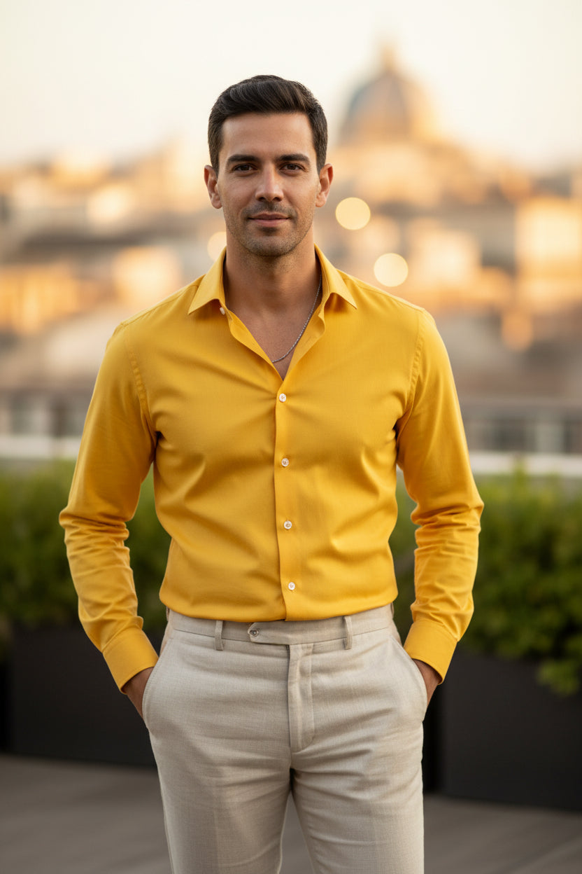 Man wearing a Yellow shirt  and beige pants with a blurred background