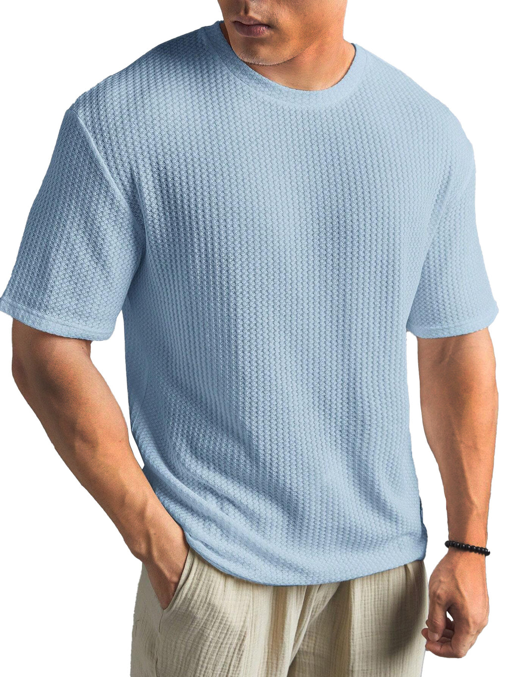 Man wearing a light blue textured t-shirt on a white background