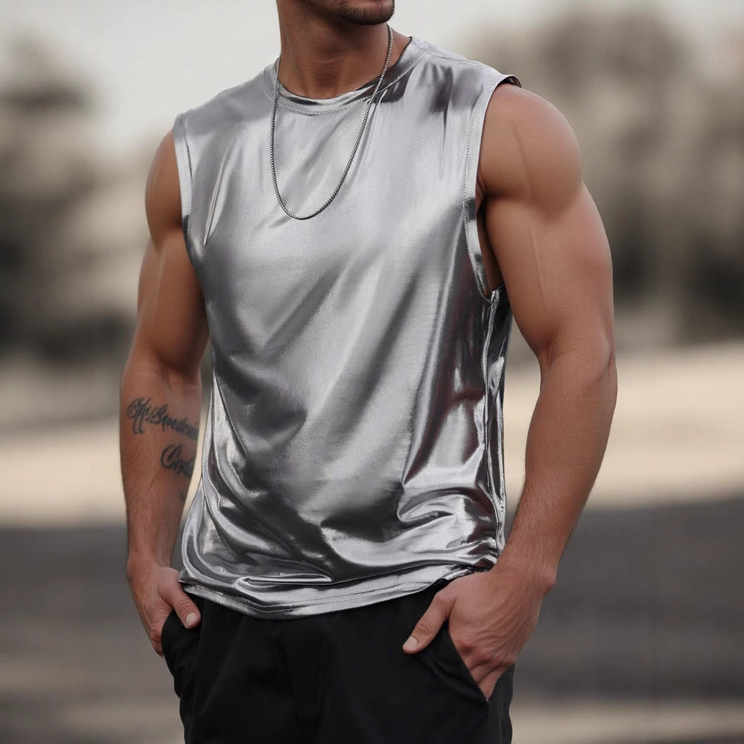 Man wearing a shiny silver tank top with a blurred background