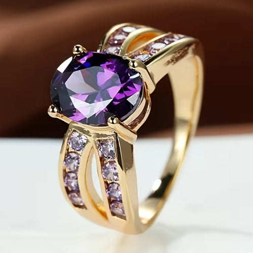 Gold ring with a purple gemstone on a white background