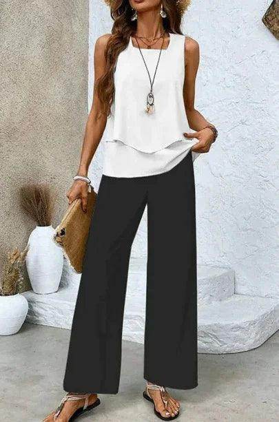 Woman wearing sleeveless white blouse, black wide-leg pants, and sandals, styled for ZA-Zola fashion.