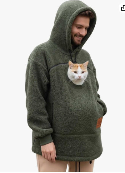 Person wearing a green hoodie with a cat face design on a white background