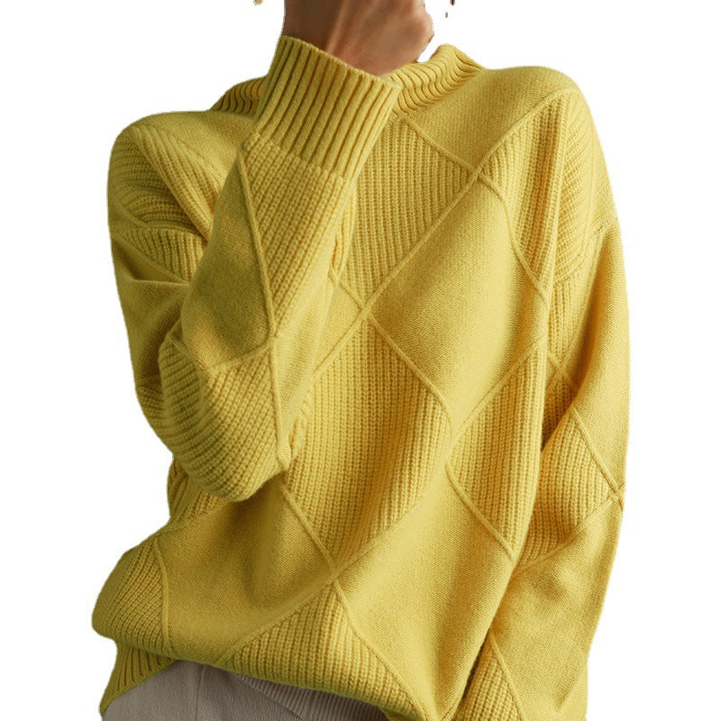 Yellow knitted sweater with a textured pattern on a white background