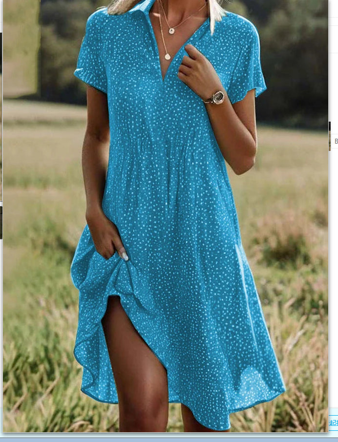 Woman wearing a blue polka dot dress in an outdoor setting