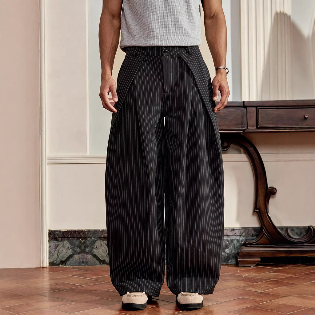 Person wearing black pinstripe pants in an indoor setting