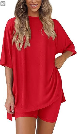 Woman wearing a red outfit with a loose-fitting top and shorts on a white background