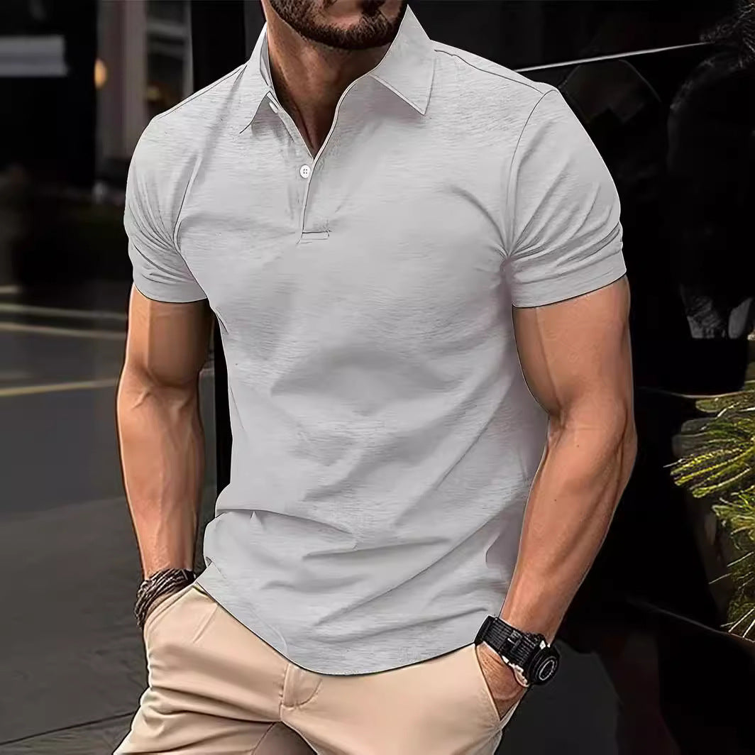 Man wearing a light gray polo shirt and beige pants in an urban setting