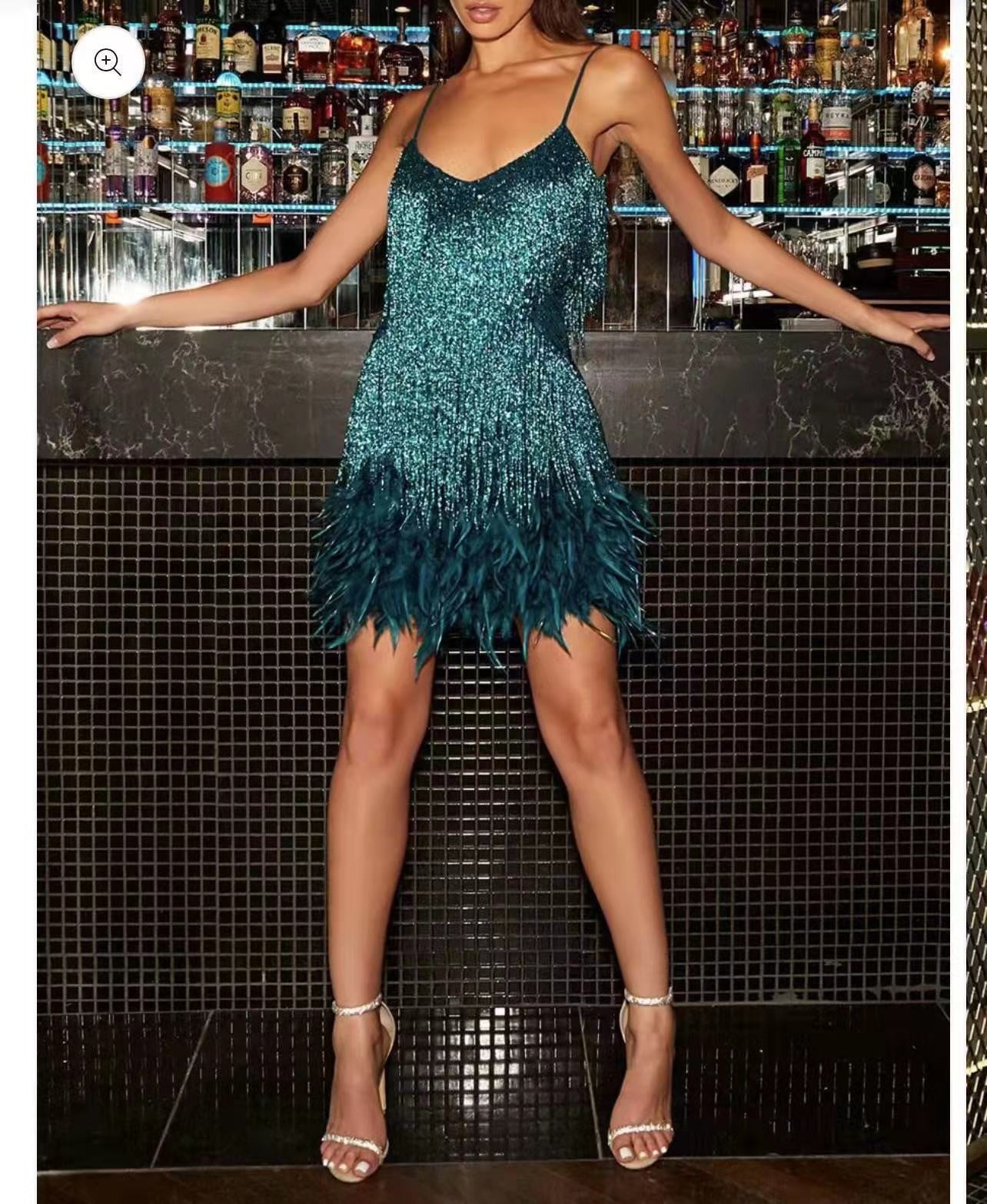 Woman wearing a green sequin dress in a bar setting