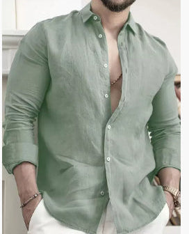 Man wearing a green shirt with a blurred background