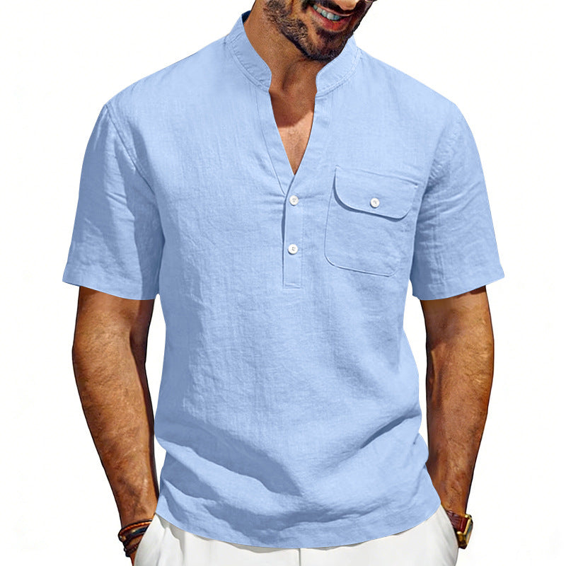 Man wearing a light blue short-sleeve shirt with a pocket on a white background