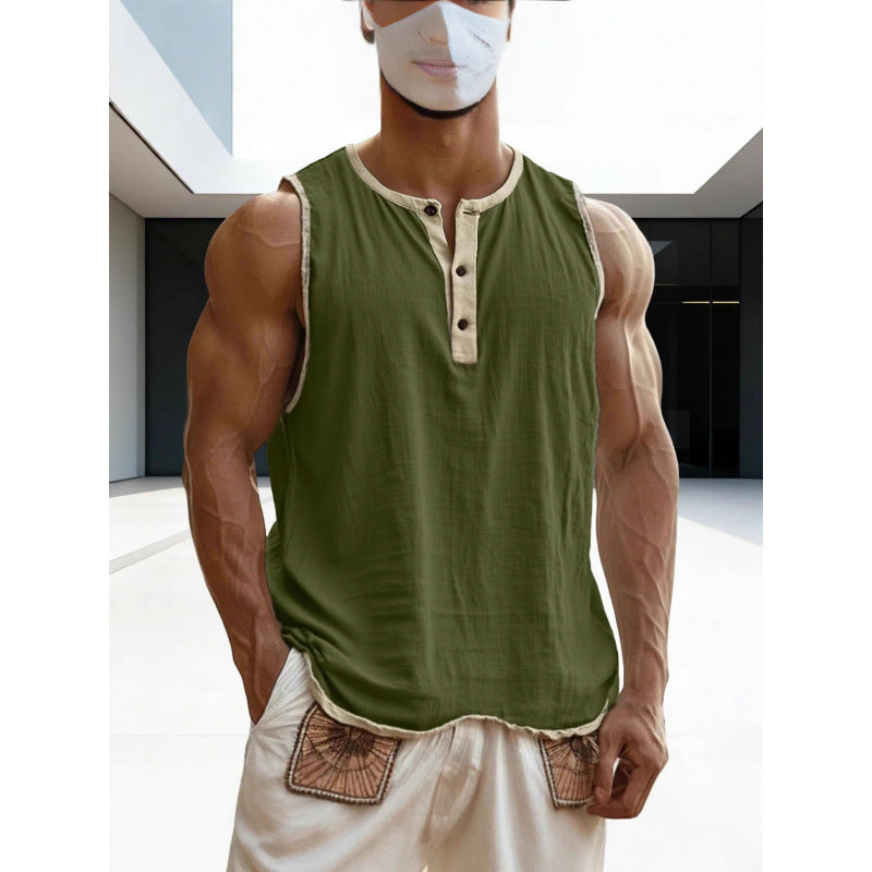 Person wearing a green sleeveless shirt with beige trim and white pants in an indoor setting.