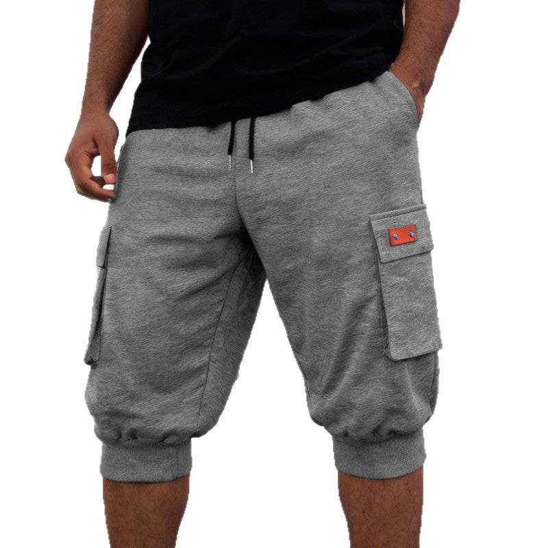 Gray cargo shorts with a red patch on a white background