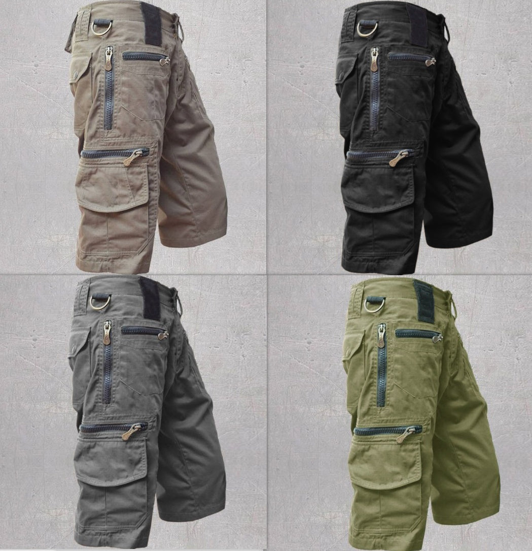 Four different colored tactical shorts on a gray background