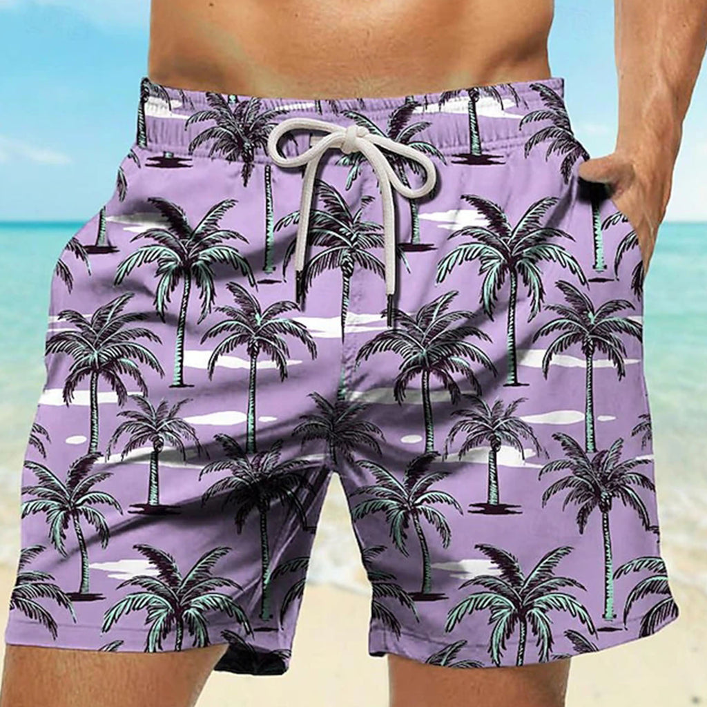 Purple beach shorts with palm tree pattern worn by a person on a beach.