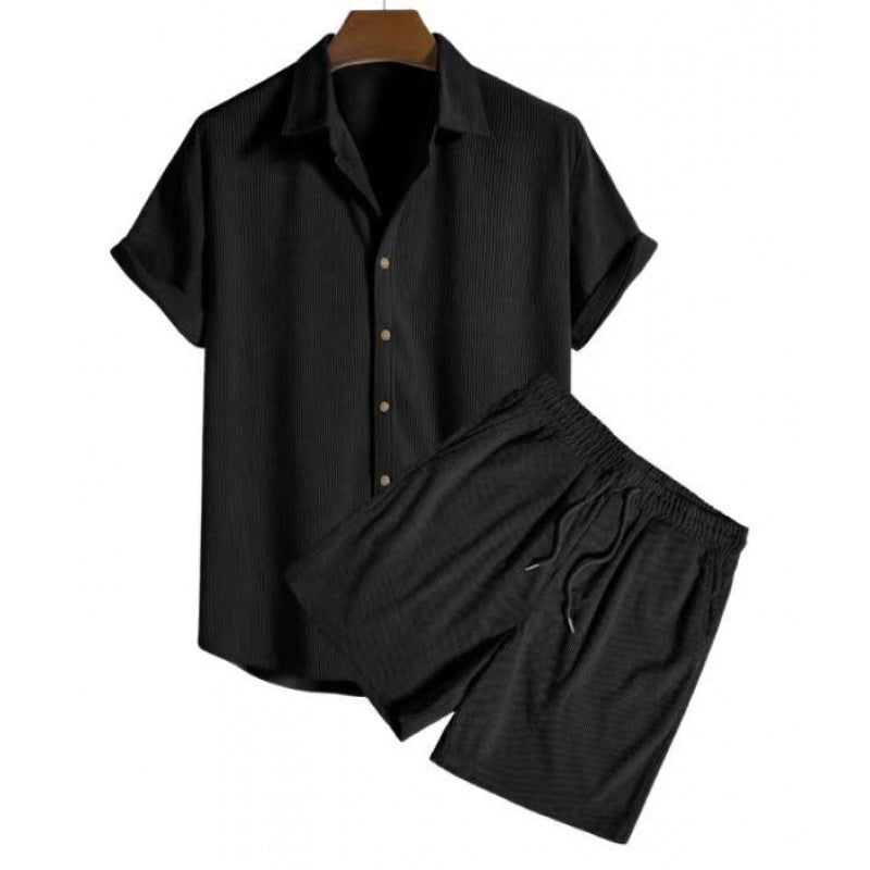 Black short-sleeve shirt and shorts set on a white background