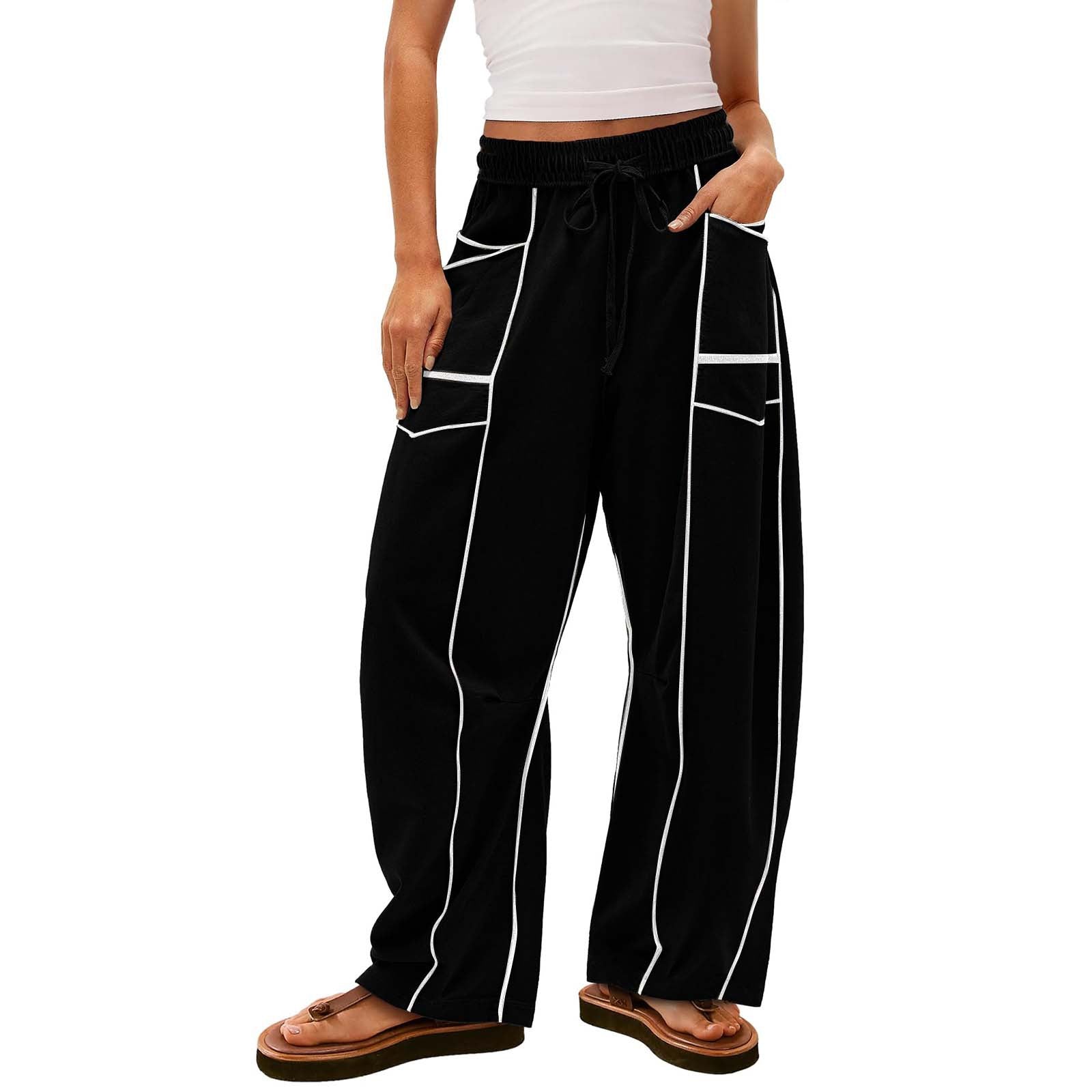 Black pants with white stripes worn by a person on a white background
