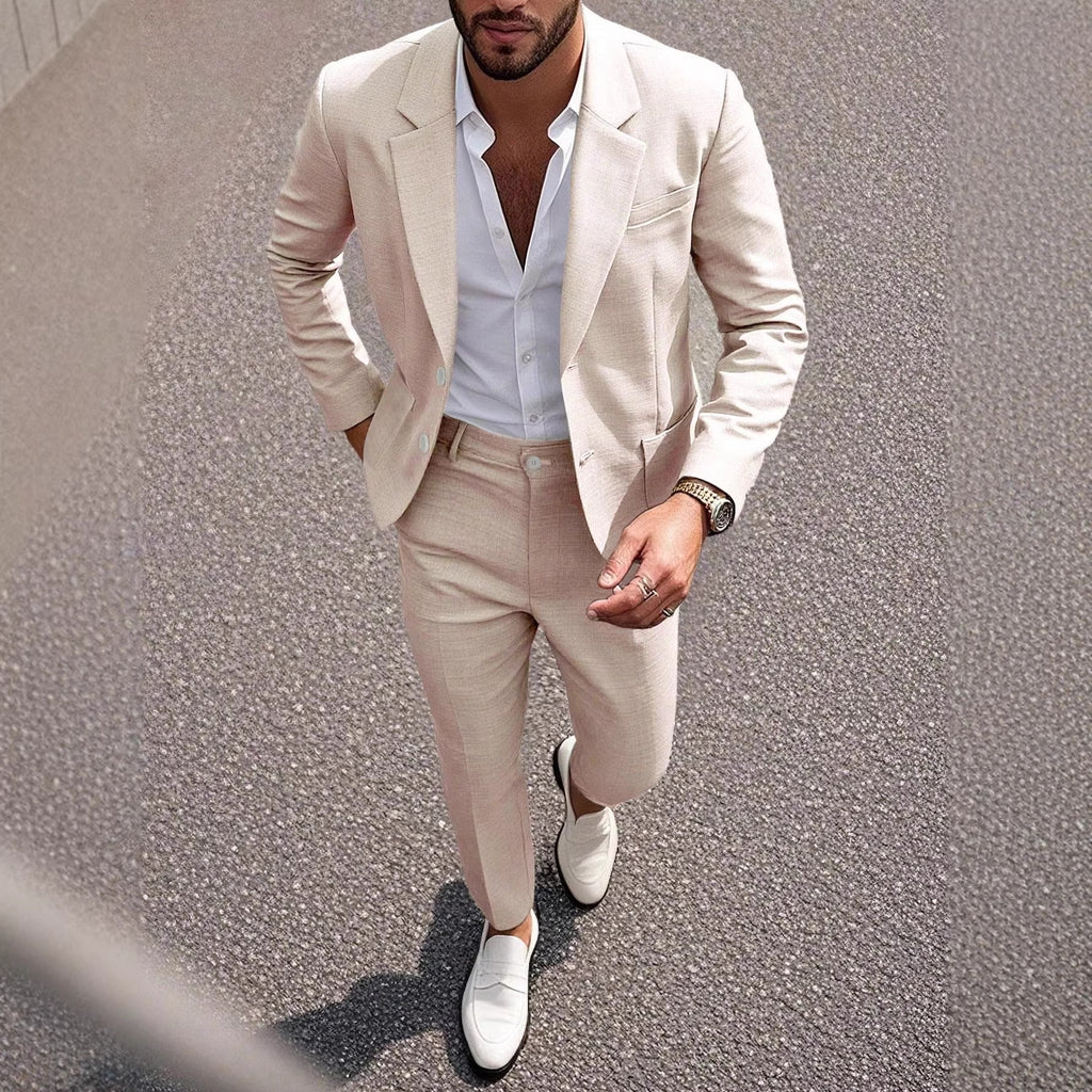Man wearing a beige suit with white shirt and shoes on a street.