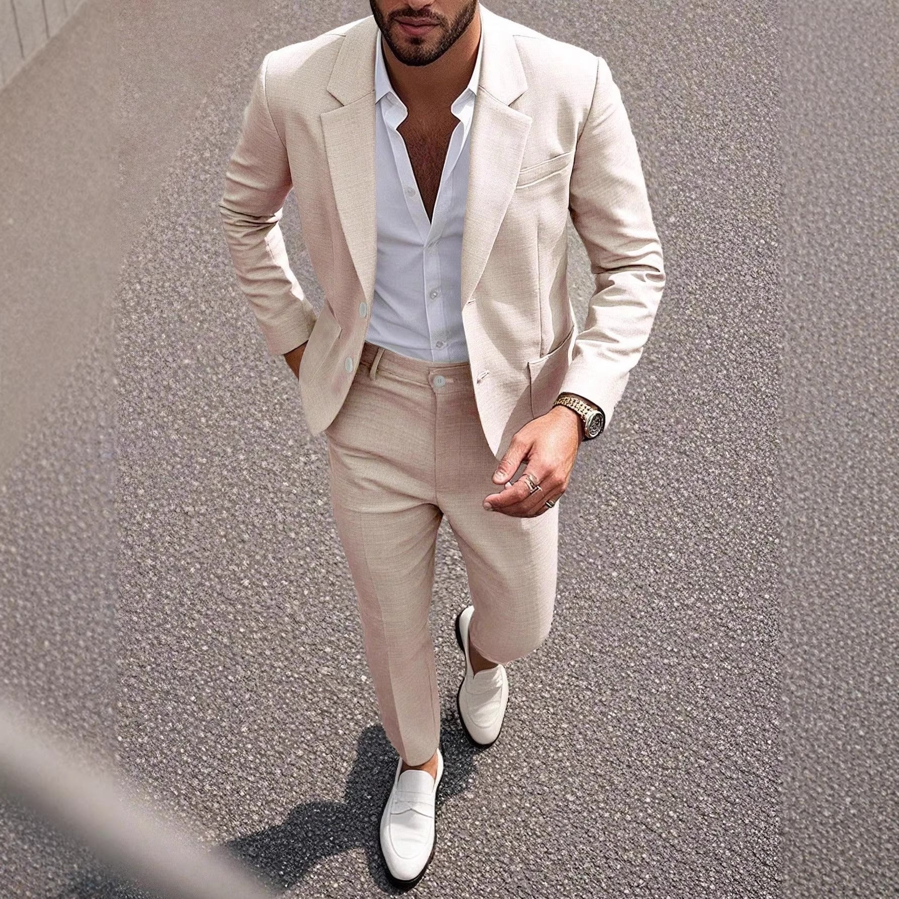 Man wearing a beige suit with white shirt and shoes on a street.