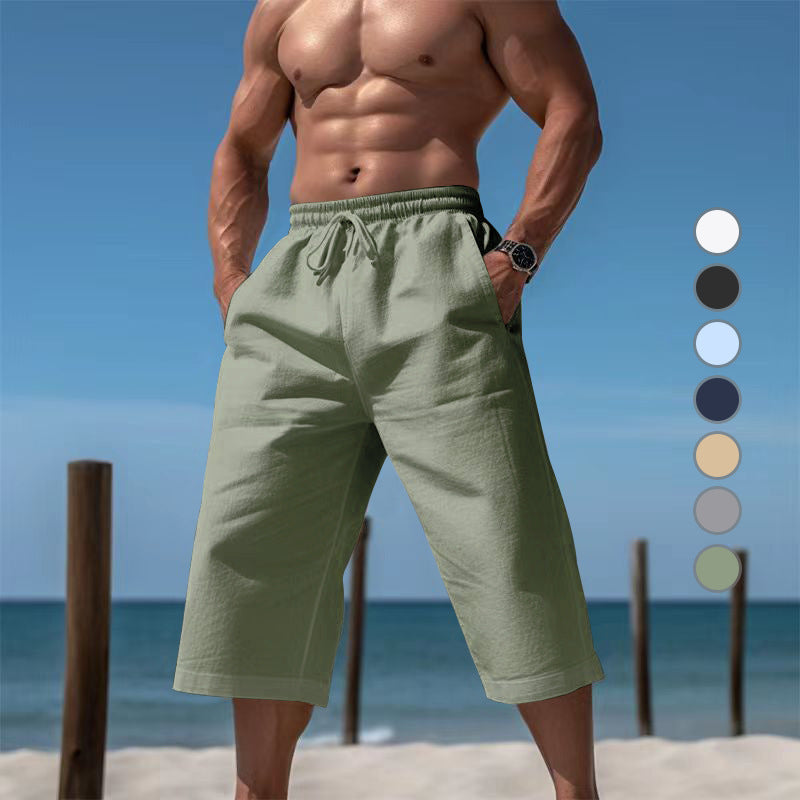 Man wearing green shorts on a beach with color swatches.
