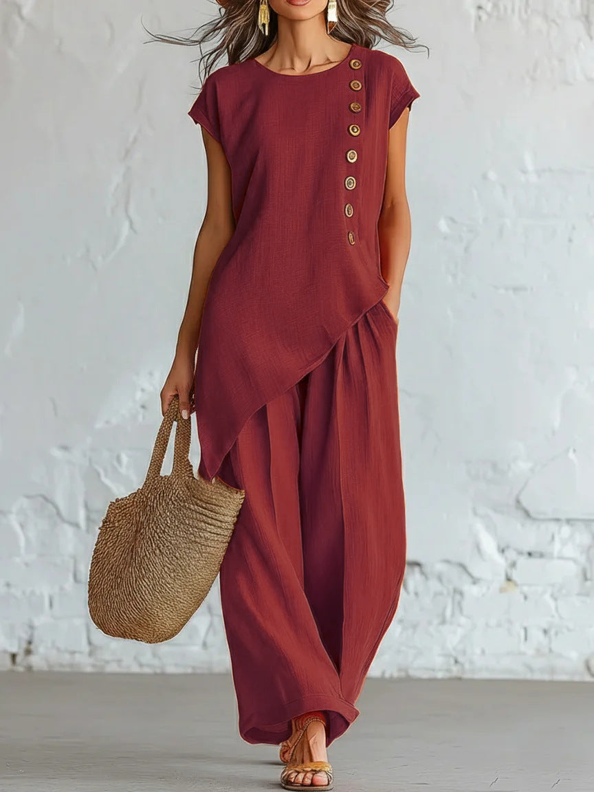 Woman wearing a burgundy dress with a white textured wall background