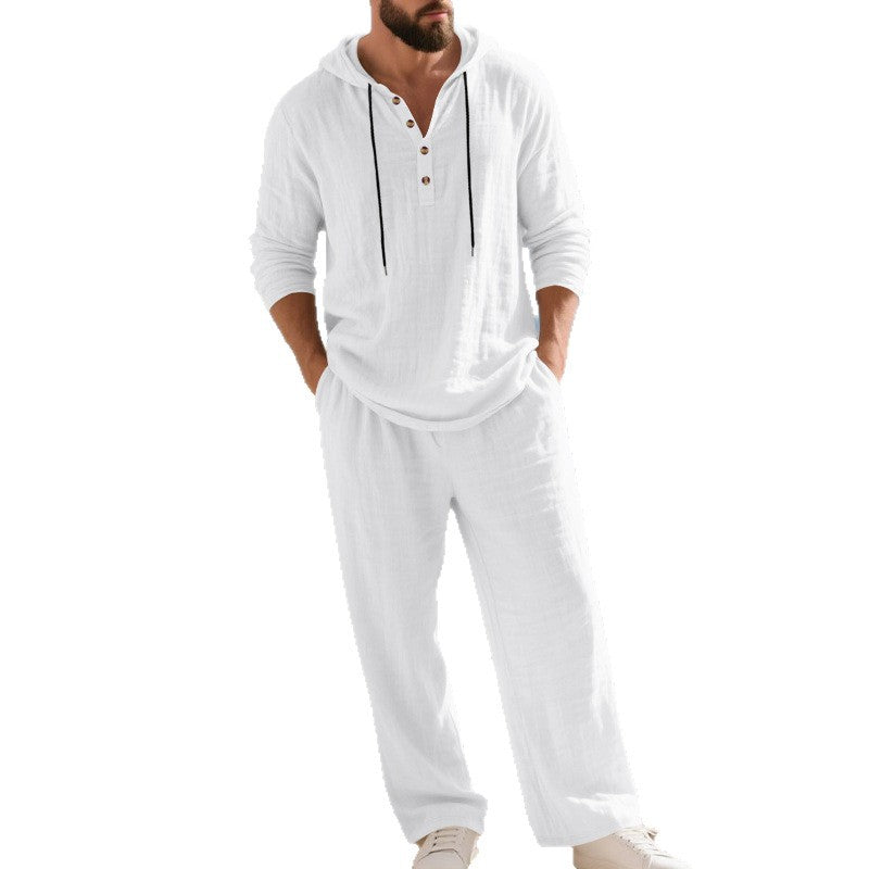 Man wearing a white hoodie and pants set on a white background