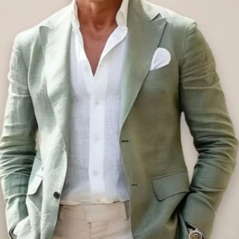 Green blazer over a white shirt with beige pants on a plain background