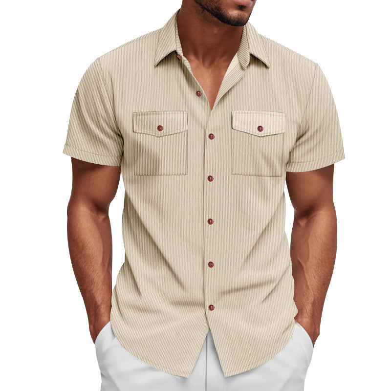 Man wearing a beige short-sleeve shirt with red buttons on a white background