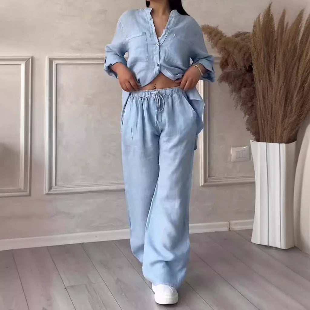Person wearing a light blue outfit in a room with decorative elements.