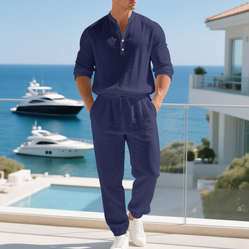 Man wearing a blue long-sleeve shirt and pants on a white background
