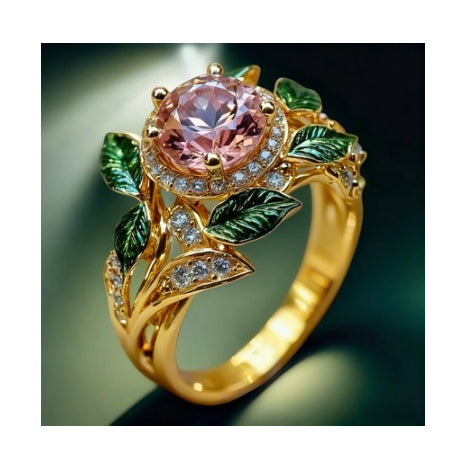 Gold ring with pink gemstone and green leaves on a dark background