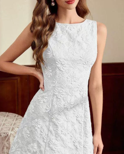 White lace dress worn by a model with a neutral background