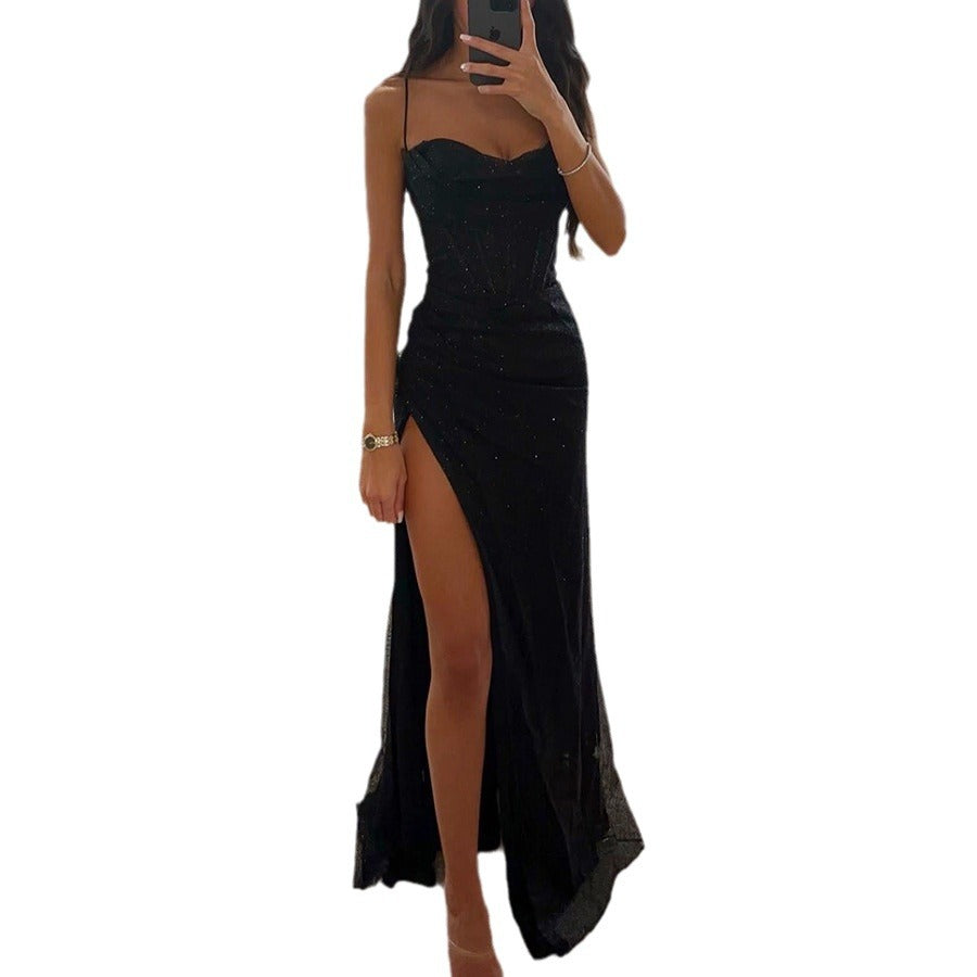 Black strapless dress with a high slit on a white background