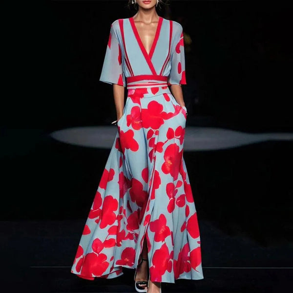 Woman wearing a floral dress with red and blue pattern on a dark background