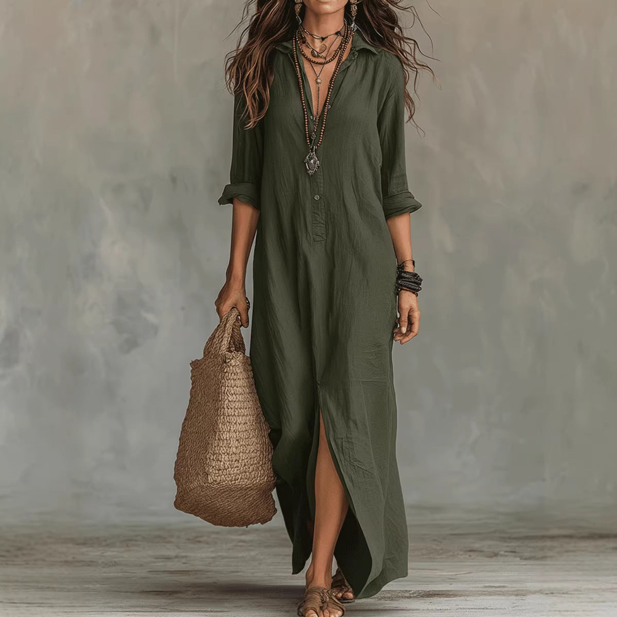 Woman wearing an olive green dress holding a woven bag against a neutral background