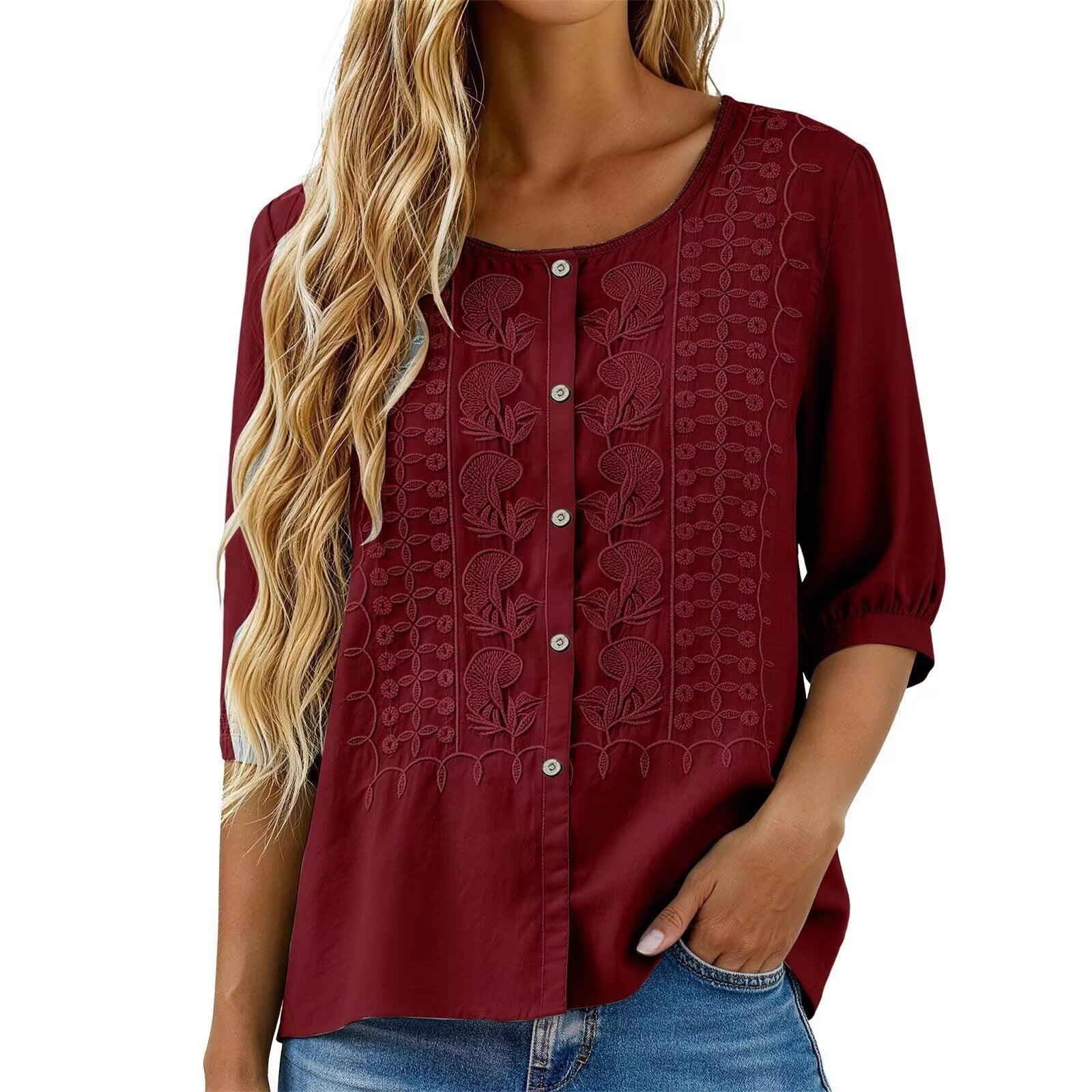 Red blouse with floral embroidery on a white background