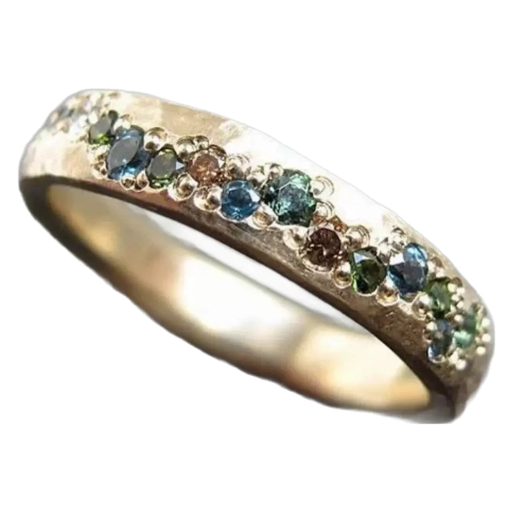 Gold ring with embedded multicolored gemstones on a white background