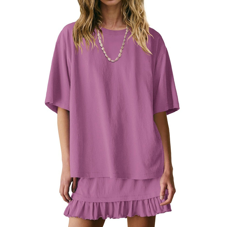 Purple dress with a ruffled skirt worn by a model on a white background