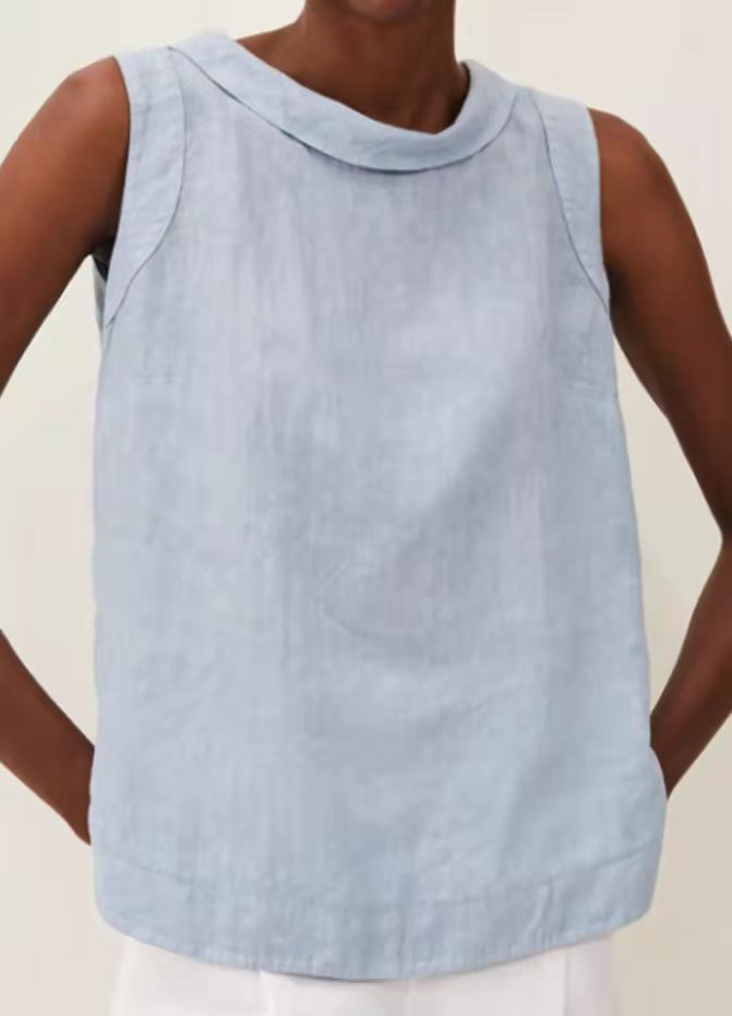Light blue sleeveless top worn by a person on a plain background