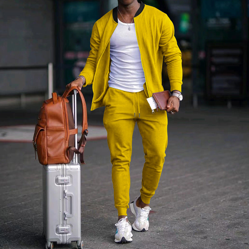 Person in yellow tracksuit with suitcase and backpack on a blurred street background