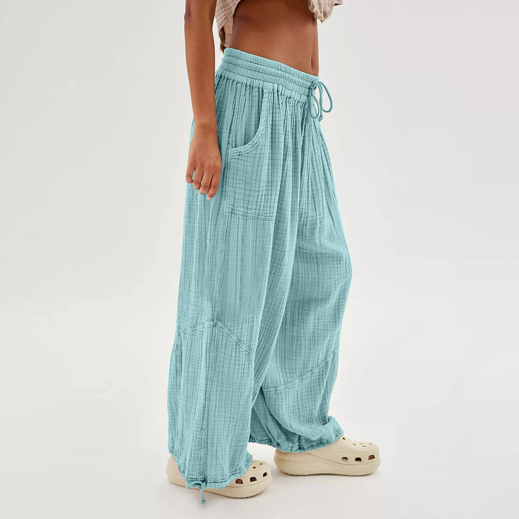 Teal checkered pants worn by a person on a white background