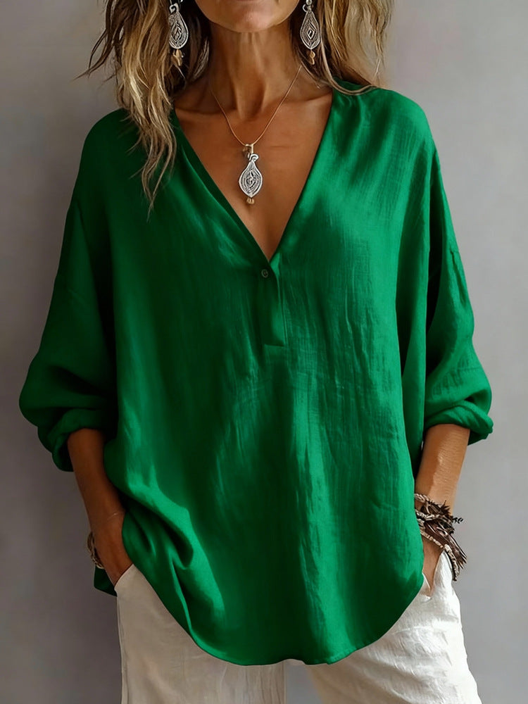 Person wearing a green blouse with a plain background