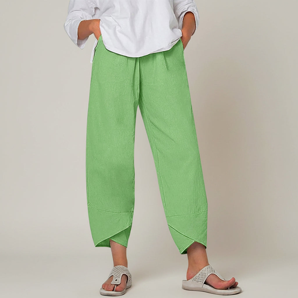 Person wearing green pants and a white shirt on a white background