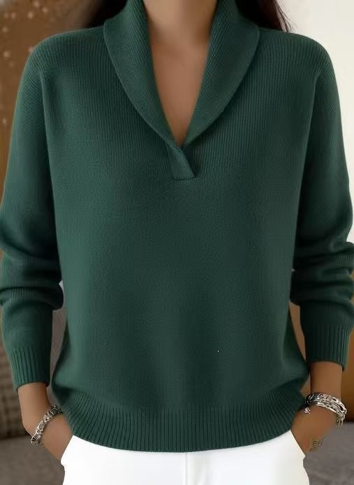 Green sweater worn by a person with a neutral background