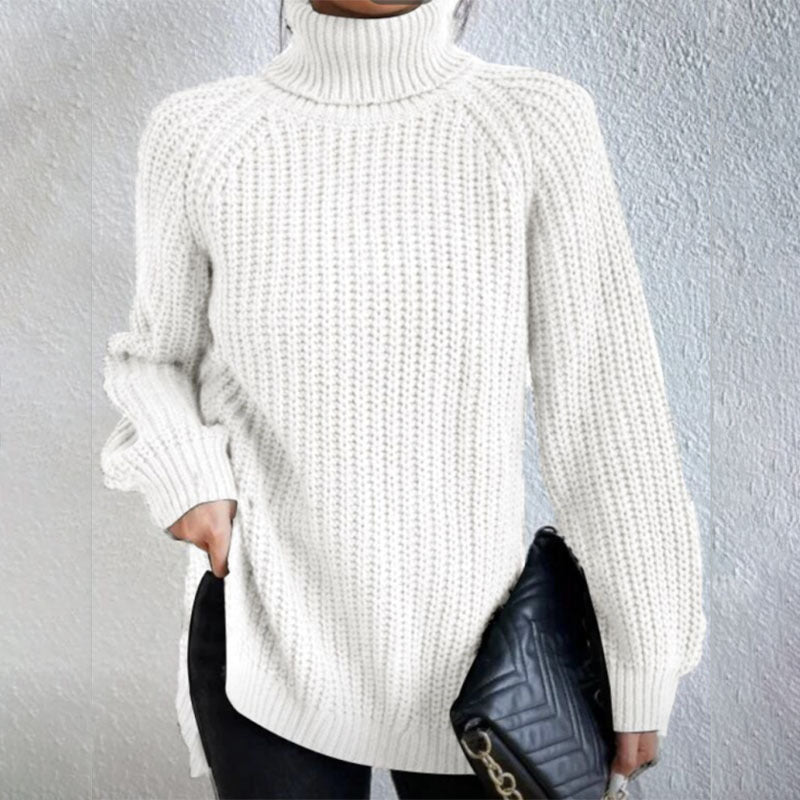 Person wearing a white turtleneck sweater against a gray background