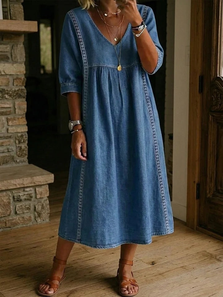 Woman wearing a blue denim dress indoors.